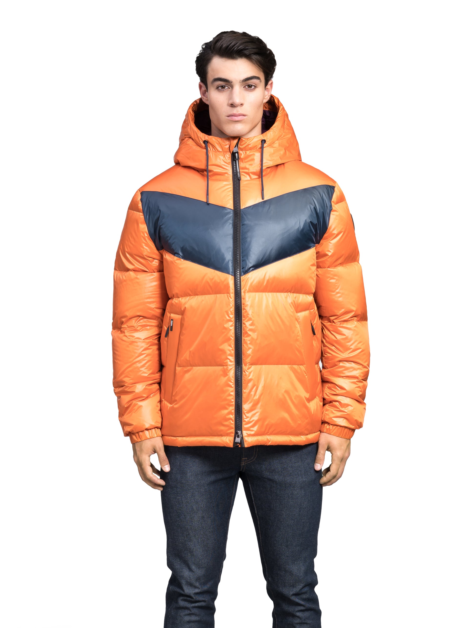 Dyna Men's Chevron Quilted Puffer Jacket in hip length, premium cire technical nylon taffeta fabrication, Premium Canadian origin White Duck Down insulation, non-removable down-filled hood, two-way centre-front zipper, fleece-lined zipper pockets at waist, pit zipper vents, in Burnt Orange