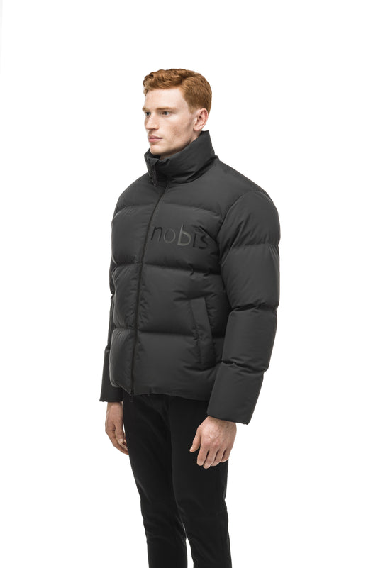 Men's puffer jacket with a minimalist modern design; featuring graphic details like oversized tonal branding, an exposed zipper, and seamless puffer channels in Black + Black