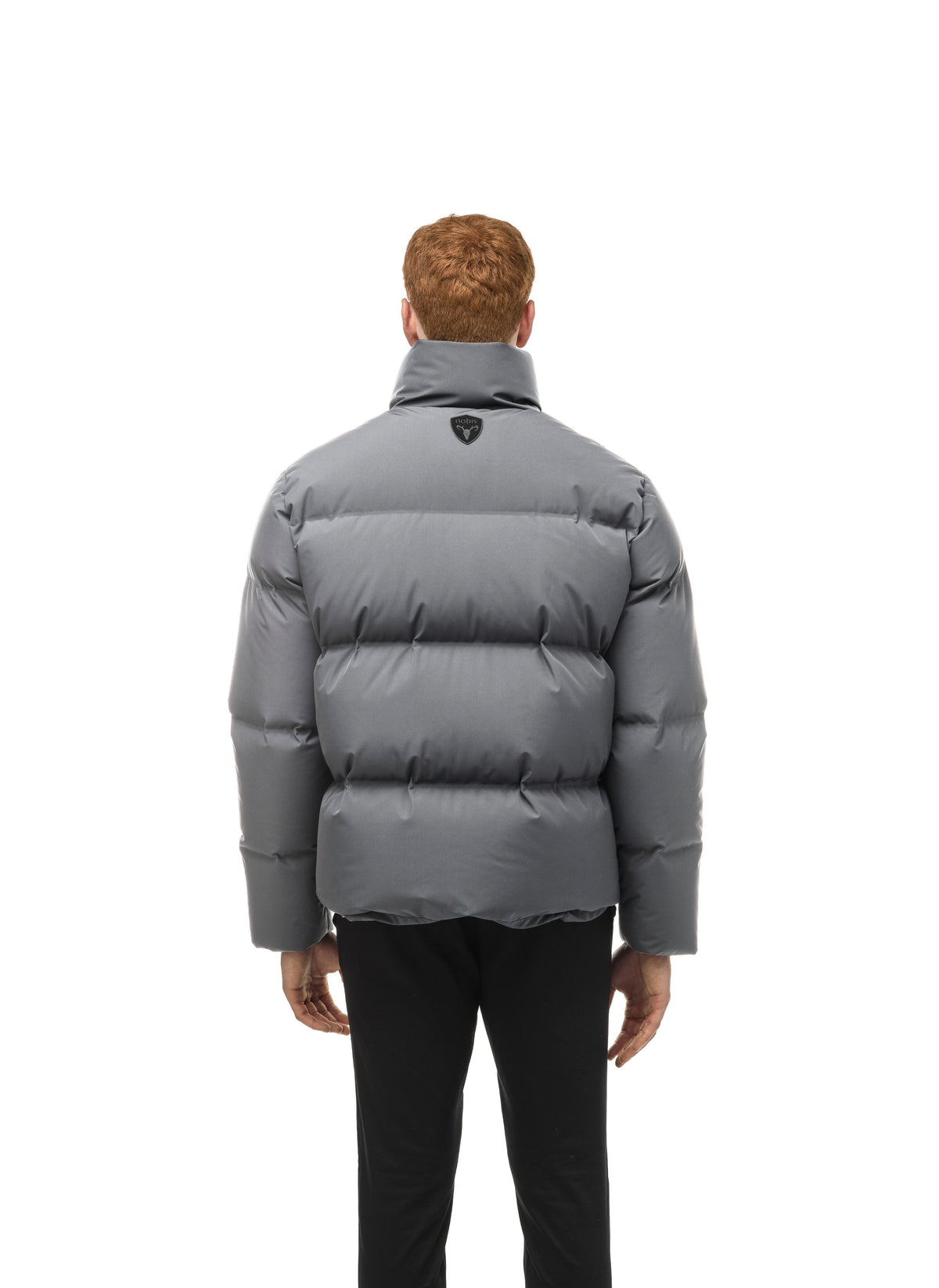 Men's puffer jacket with a minimalist modern design; featuring graphic details like oversized tonal branding, an exposed zipper, and seamless puffer channels in Concrete