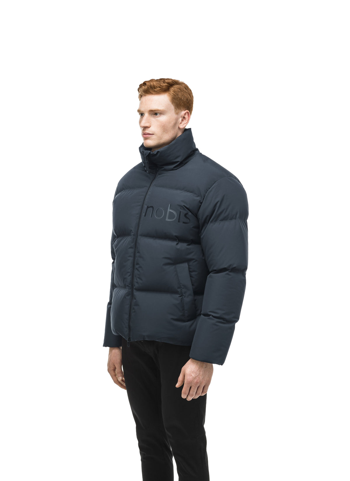 Men's puffer jacket with a minimalist modern design; featuring graphic details like oversized tonal branding, an exposed zipper, and seamless puffer channels in Midnight Blue