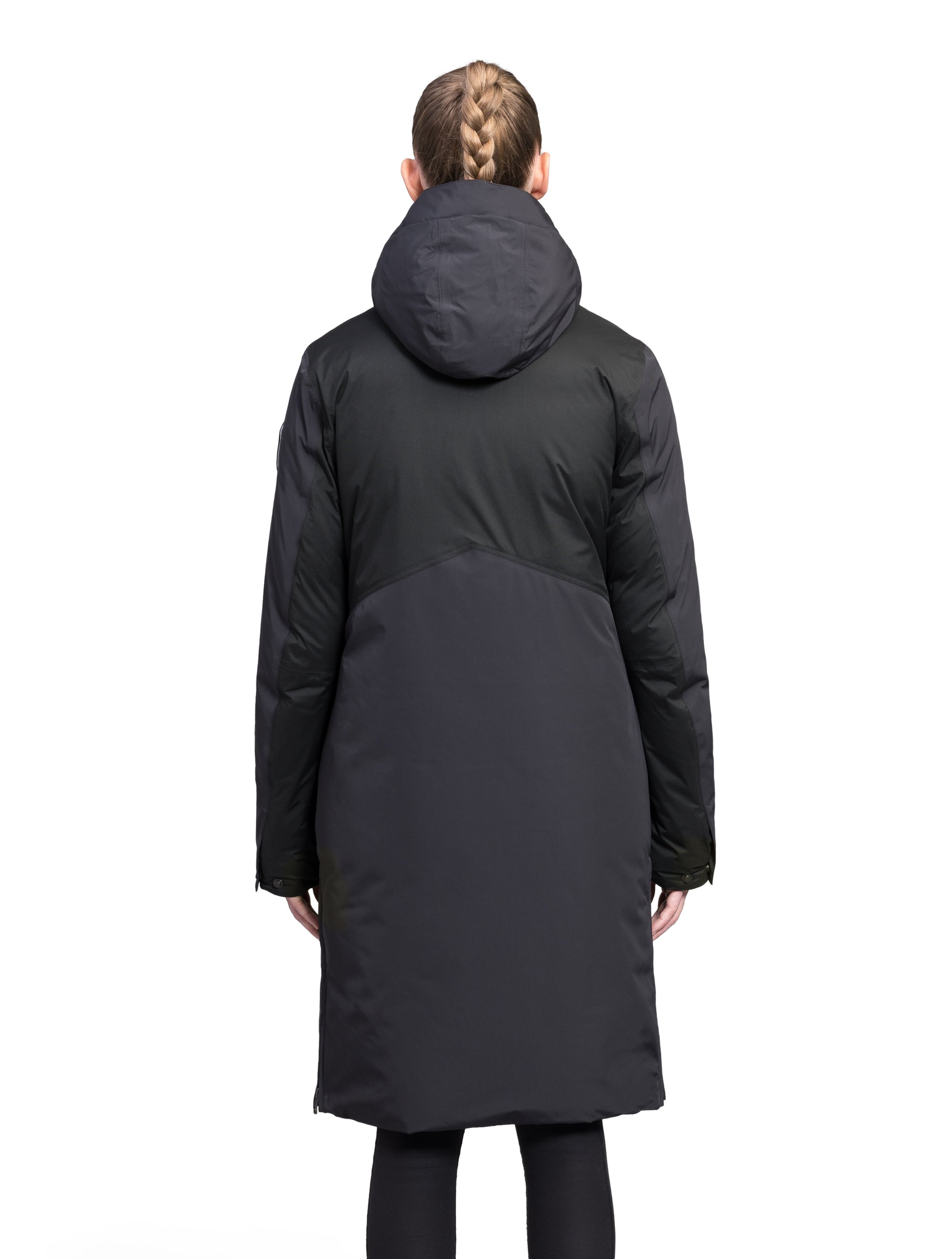 Inara Women's Performance Parka in knee length, premium 3-ply micro denier and stretch ripstop fabrication with DWR coating, Premium Canadian White Duck Down insulation, non-removable down-filled hood, centre front two-way zipper, large vertical zipper pockets along waist, zipper vents along bottom side hem, in Black