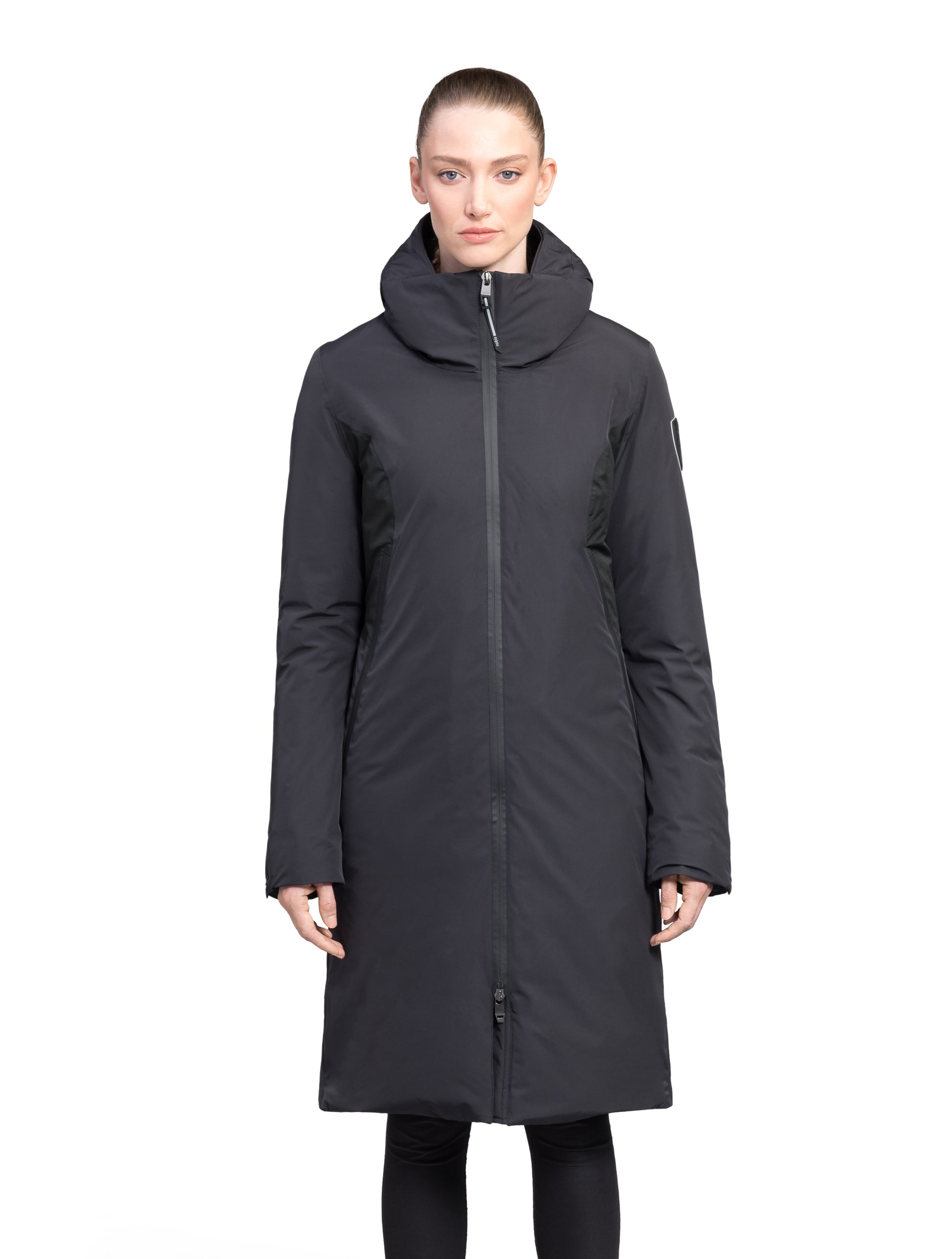 Inara Women's Performance Parka in knee length, premium 3-ply micro denier and stretch ripstop fabrication with DWR coating, Premium Canadian White Duck Down insulation, non-removable down-filled hood, centre front two-way zipper, large vertical zipper pockets along waist, zipper vents along bottom side hem, in Black