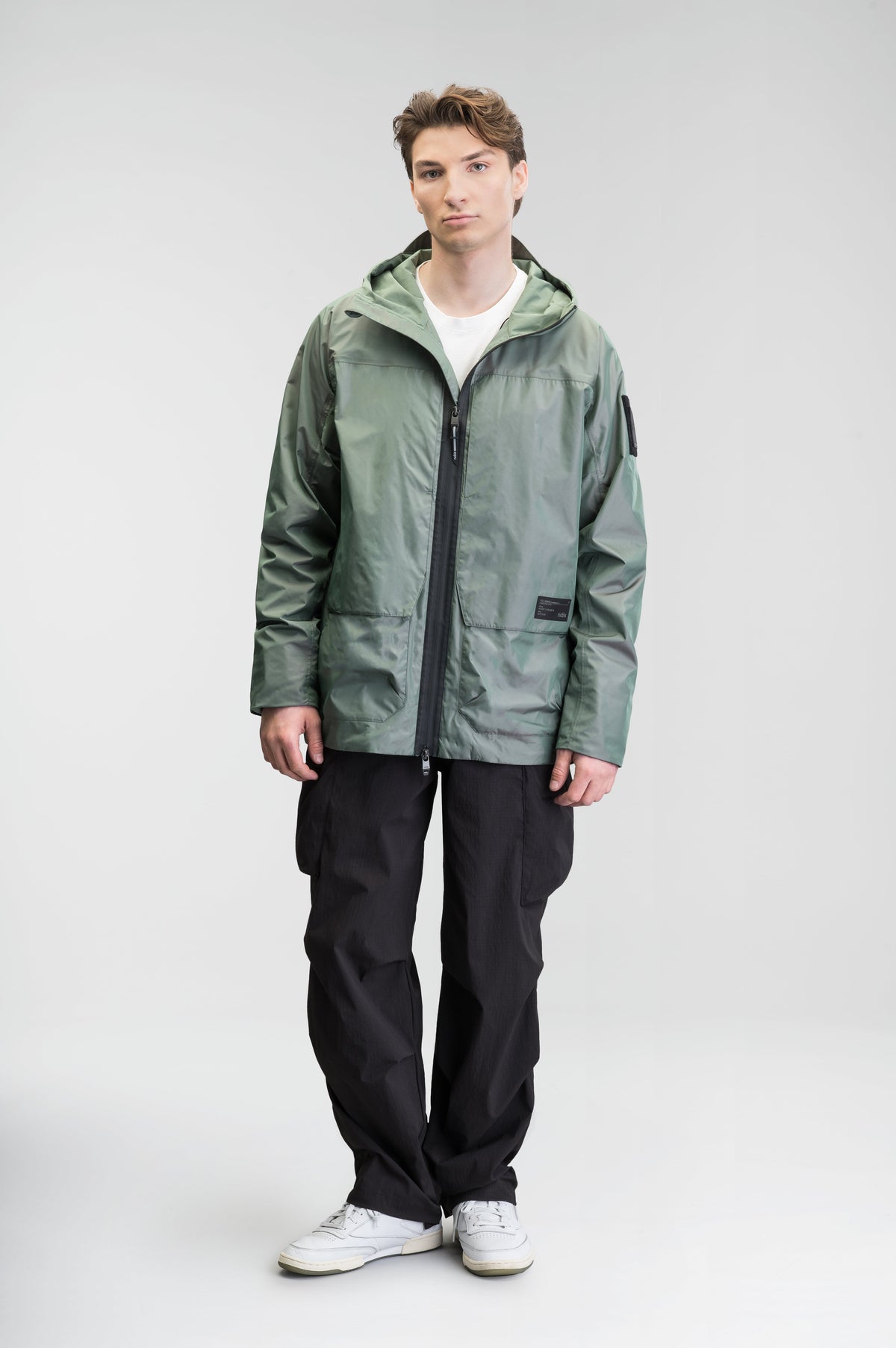 Mission Men's Performance Rain Shell Jacket in hip length, non-removable hood with adjustable toggle, two-way waterproof zipper, flap closure waist pockets with additional side entry storage, zipper ventilation on back, passive underarm ventilation, and breathable mesh lining, in Duck Green