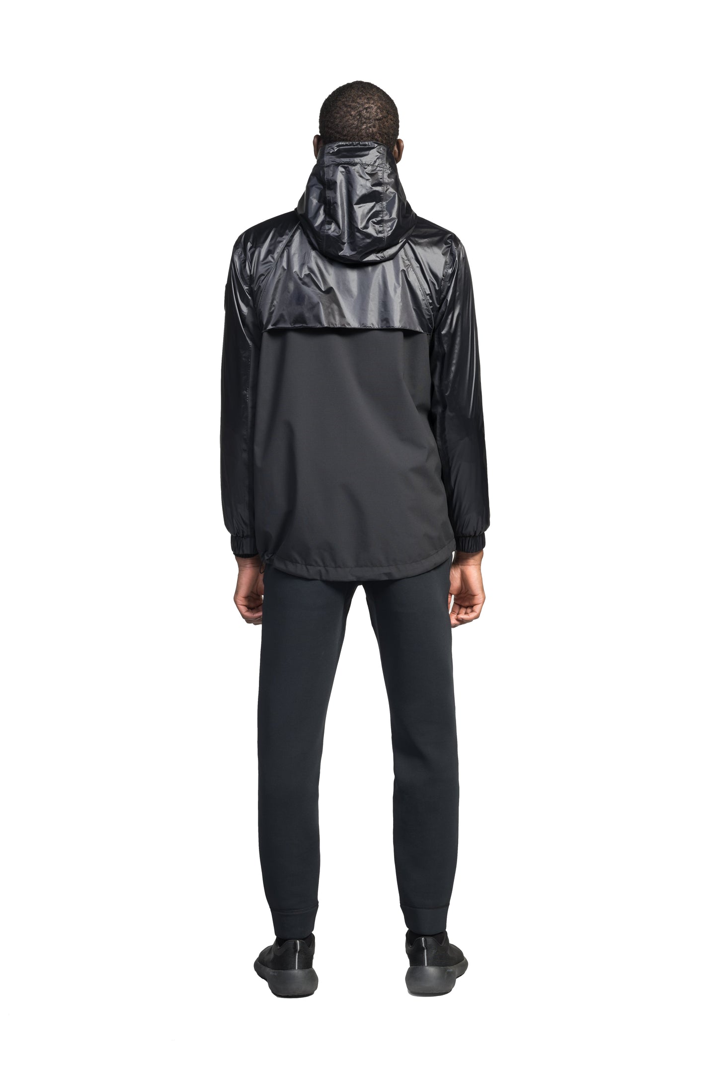 Stratus Men's Tailored Packable Rain Jacket in hip length, premium cire technical nylon taffeta and stretch ripstop fabrication, highly breathable mesh lining, hidden packable pocket, non-removable hood with adjustable draw cord, reflective piping along front and back, underarm grommets for extra breathability, back yoke with mesh ventilation, two waist zipper pockets, two interior zipper pockets, elastic cuffs with adjustable snap button, and adjustable interior draw cord at waist hem, in Black