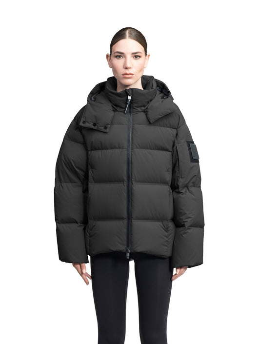 Una Ladies Performance Puffer in hip length, Technical Taffeta and Durable Stretch Ripstop fabrication, Premium Canadian White Duck Down insulation, removable down filled hood, centre front two-way zipper, and side-entry pockets at waist, in Black + Black