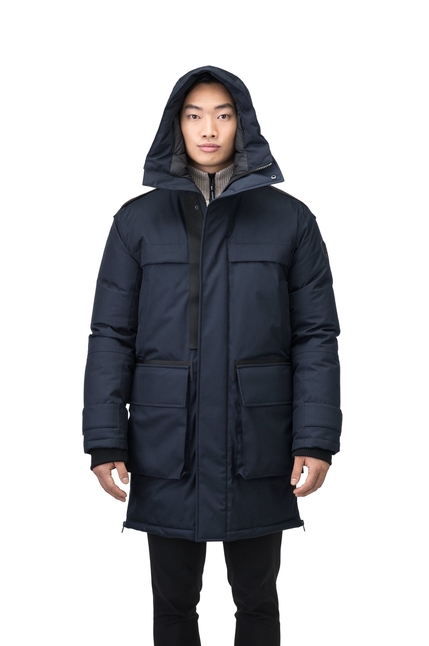 Alum Men's Long Parka in thigh length, Premium Canadian White Duck Down insulation, non-removable hood with removable coyote fur trim, two-way centre front zipper with magnetic closure wind flap, four exterior patch pockets at front, in Navy