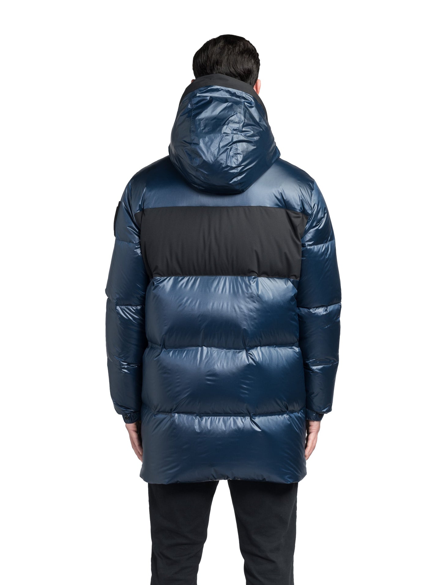 Neelix Men's Long Puffer Jacket in thigh length, premium cire technical nylon taffeta and stretch ripstop fabrication, Premium Canadian origin White Duck Down insulation, non-removable down-filled hood, two-way centre-front zipper, pit zipper vents, hidden chest zipper pockets, fleece-lined magnetic closure waist pockets, in Marine