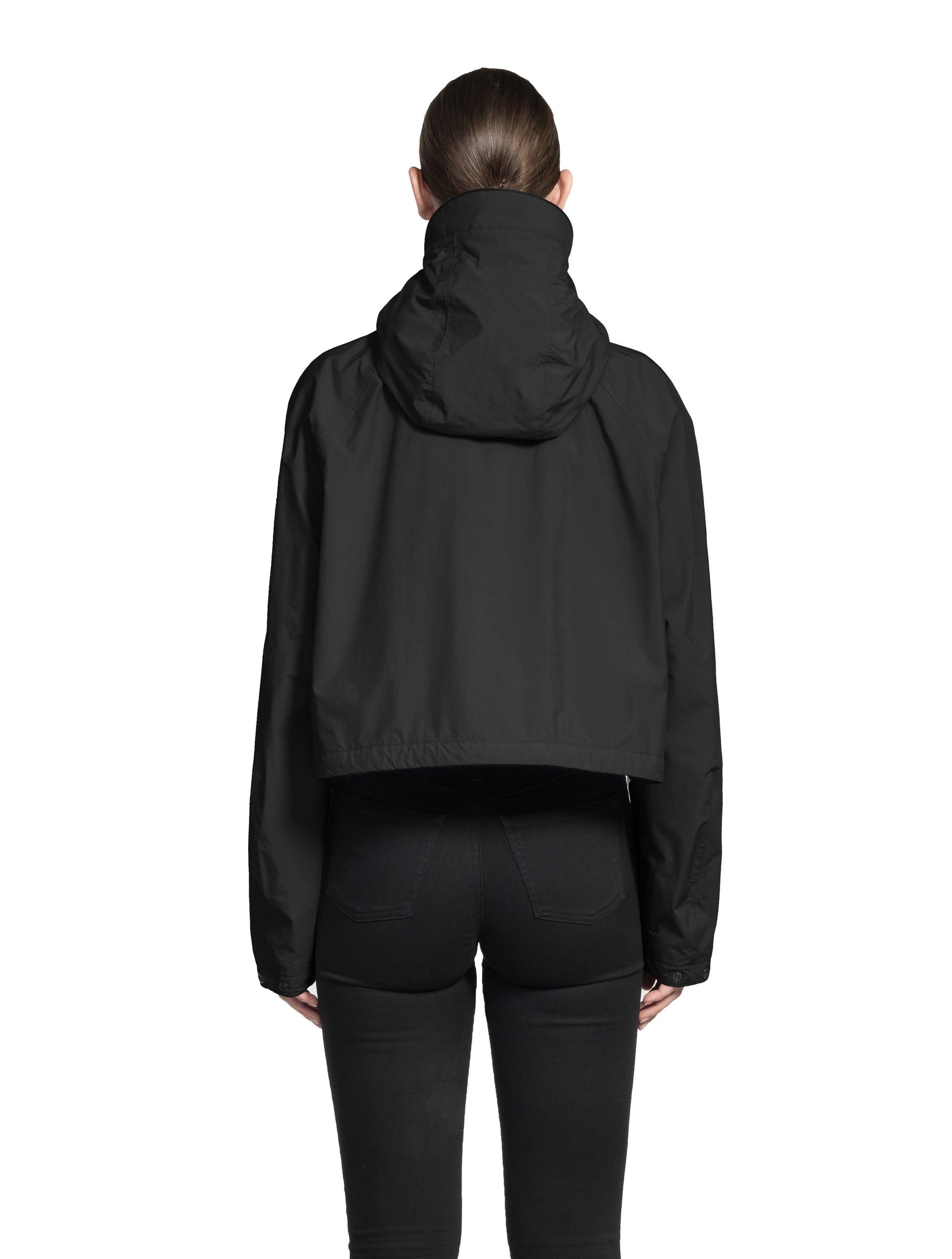 Viva Women's Performance Cropped Jacket in waist length, premium iridescent fabrication, removable hood with peak, adjustable hood draw cords and toggle, 2-way branded zipper at centre front, oversized magnetic closure flap pockets at chest with side entry, interior adjustable draw cord at hem, large interior zipper pocket, and adjustable snap cuffs, in Black